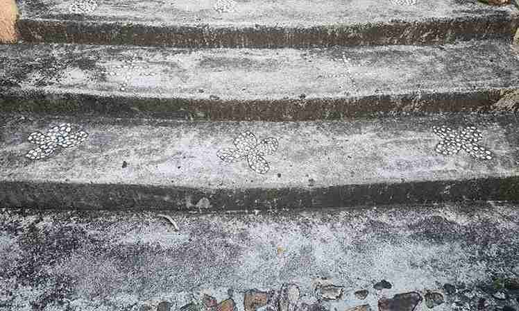Old decorative concrete steps with embedded stone patterns in North Royalton OH home.