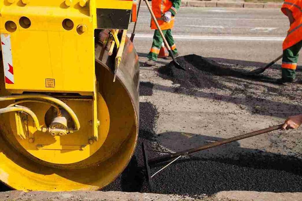 Asphalt roller machine compacting new driveway surface in North Royalton OH.