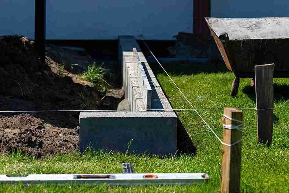 Concrete retaining wall with drainage installed on sloped yard in North Royalton OH